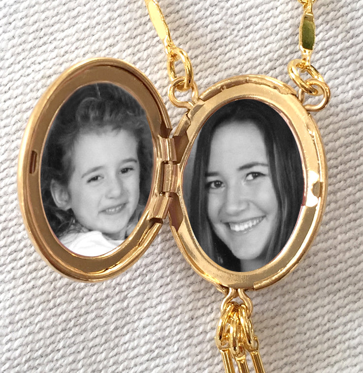 Open gold locket with two photos