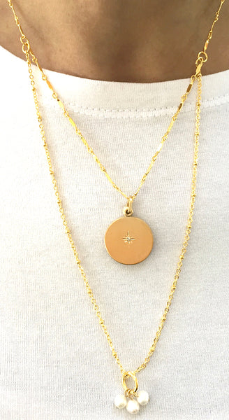 Necklace with slide locket. Locket is round with north star in center